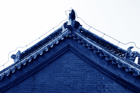 Temple eaves and beast sculpture, closeup of photoの写真素材