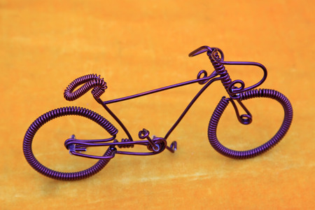 bicycle made by iron wire in orange backgroundの写真素材