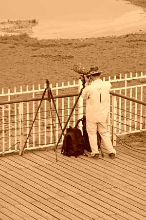 QINHUANGDAO CITY- JUNE 1: Male photographer was photographing in a wetland park, June 1, 2014, Qinghuangdao city, Hebei Province, Chinaのeditorial素材