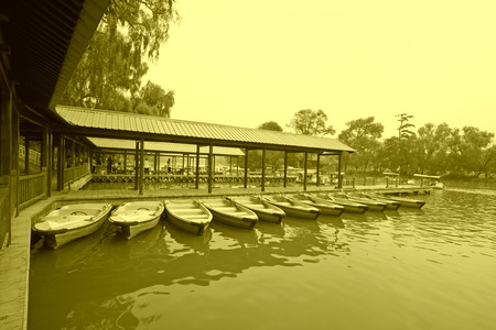 small vessels arranged together in a lake, in the fall, north chinaのeditorial素材