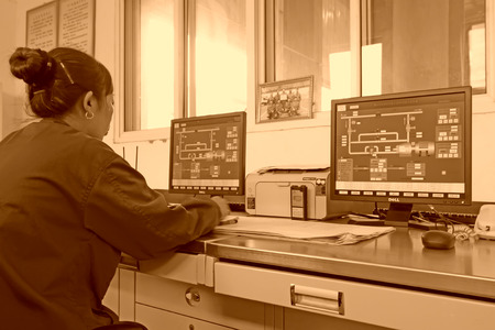 TANGSHAN - JUNE 18: Female technician in view display state in the control room, in a iron and steel co., on June 18, 2014, Tangshan city, Hebei Province, Chinaのeditorial素材