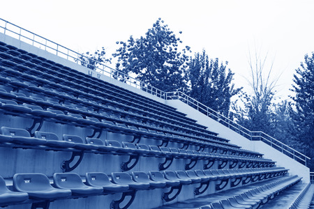 empty blue and green stadium seats in a university campus, beijing, north chinaのeditorial素材