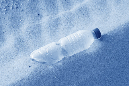 disused beverage bottle on the beach at the seaside, north chinaの写真素材