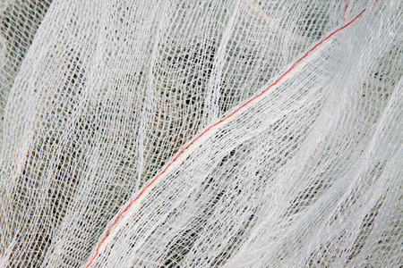 White nylon fishing nets, closeup of photoの写真素材