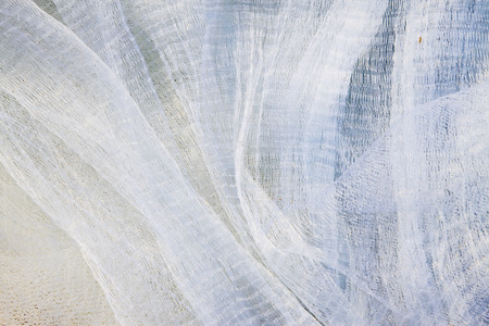 White nylon fishing nets, closeup of photoの写真素材