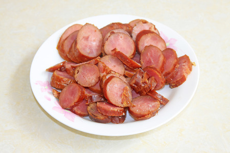 Sausage slices on a plate in a restaurantの写真素材