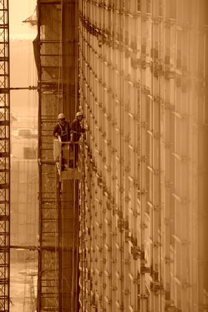 Luannan County, May 18: Construction workers in high rise building doing decoration works on May 18, 2012, Luannan County, Hebei Province, Chinaのeditorial素材