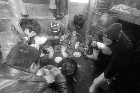 Luannan County, April 1: Workers were having lunch in the cabin of fishing boat in the ZuiDong fishing Wharf on April 1, 2012, Luannan County, Hebei Province, China.のeditorial素材