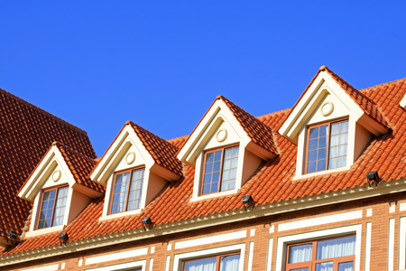 Loft exotic landscape architecture and small attic window under blue skyのeditorial素材