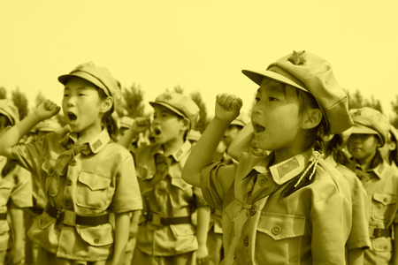 Elementary student dressed in blue military uniform and swear solemnly のeditorial素材