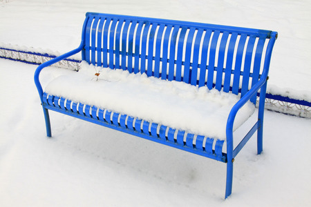 Metallic blue chairs in the snow, closeup of photoの写真素材