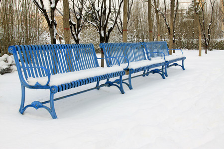 Metallic blue chairs in the snow, closeup of photoの写真素材