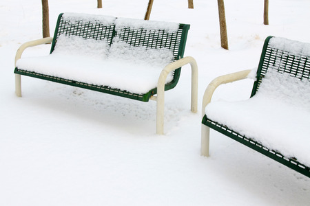 Metallic blue chairs in the snow, closeup of photoの写真素材