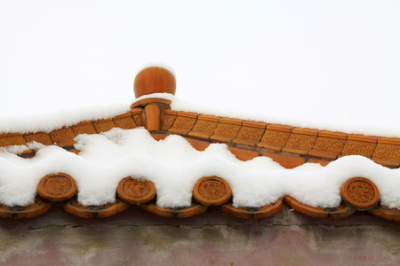 Chinese traditional glazed tile and snow, closeup of photoの写真素材