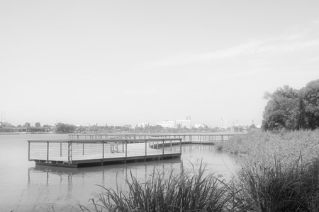 Curved bridge and green landscape at a water park, northern chinaの写真素材