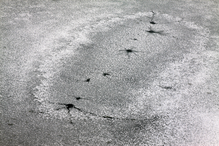 cracked ice on river in winterの写真素材