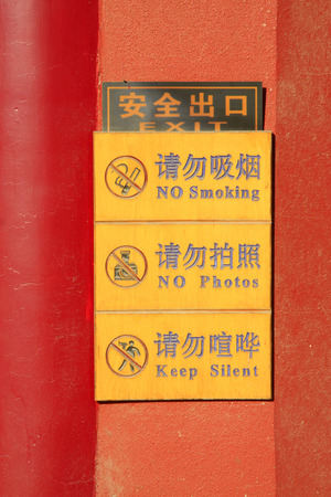 yellow warning mark on red background, closeup of photoの写真素材