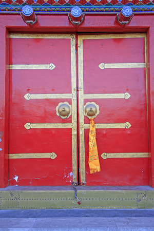 Red door in a temple, closeup of photoの写真素材
