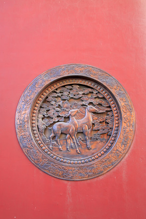 Deer modelling lattice on red wall, closeup of photoの写真素材