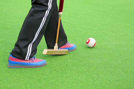 Chinese gate ball and athlete's legs, closeup of photo