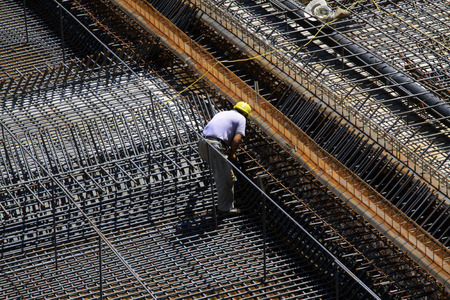 Construction workers making reinforced concrete frame in the construction siteの写真素材