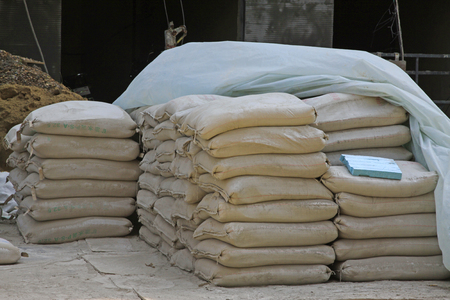 Bagged cement in the construction site, closeup of photoのeditorial素材