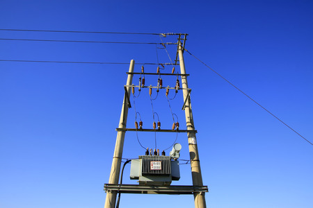 Transformer and pole under the blue sky, closeup of photoの写真素材