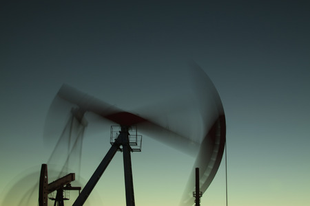 Crank balanced beam pumping unit in the oil field, closeup of photoの写真素材