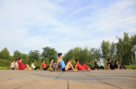 Tangshan - July 3: women doing yoga exercise in the park, July 3, 2016, tangshan city, hebei province, Chinaのeditorial素材