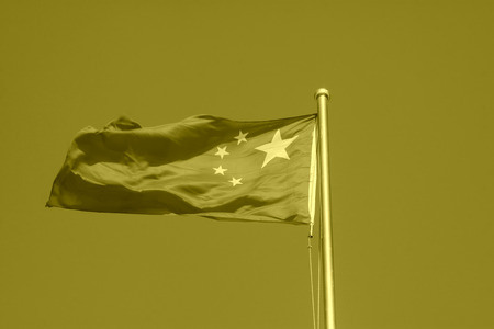 Chinese national flag in blue sky background, closeup of photo