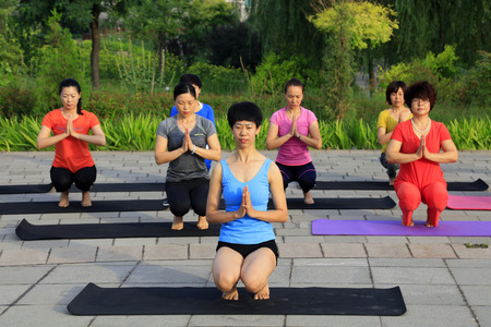 Tangshan - July 3: women doing yoga exercise in the park, July 3, 2016, tangshan city, hebei province, Chinaのeditorial素材