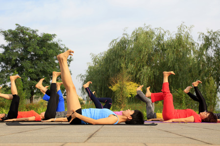 Tangshan - July 3 2016: women doing yoga exercise in the park, tangshan city, hebei province, Chinaのeditorial素材