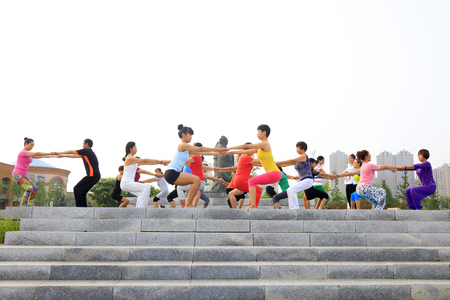 Tangshan - July 17: women doing yoga exercise in the park, July 17, 2016, tangshan city, hebei province, Chinaのeditorial素材