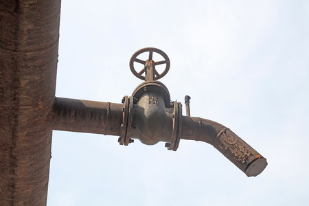 oxidize pipeline and handwheel in a factory, closeup of photoのeditorial素材