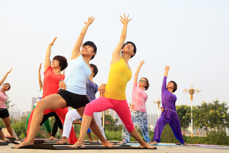 Tangshan - July 17: women doing yoga exercise in the park, July 17, 2016, tangshan city, hebei province, Chinaのeditorial素材