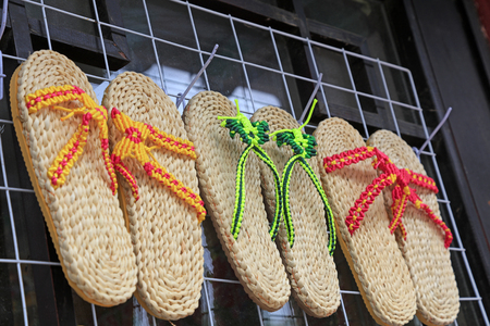hung sandals on the wall, closeup of photoの写真素材