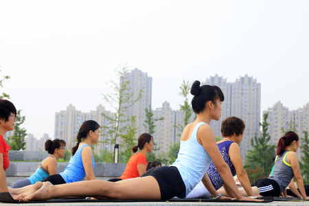 Tangshan - July 17: women doing yoga exercise in the park, July 17, 2016, tangshan city, hebei province, Chinaのeditorial素材