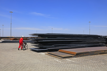 Workers and steel plate in the cargo terminalのeditorial素材