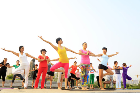 Tangshan - July 17: women doing yoga exercise in the park,  2016, tangshan city, hebei province, Chinaのeditorial素材