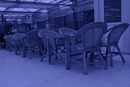 Bamboo chair and glass tea table, closeup of photoのeditorial素材