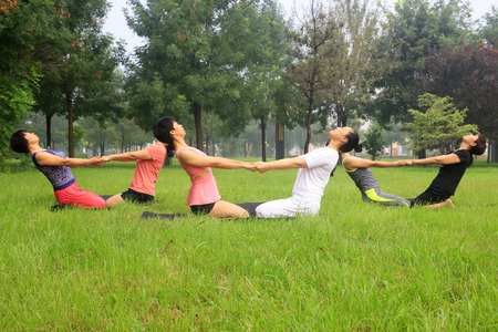 Tangshan - August 17: women doing yoga exercise in the park, August 17, 2016, tangshan city, hebei province, Chinaのeditorial素材