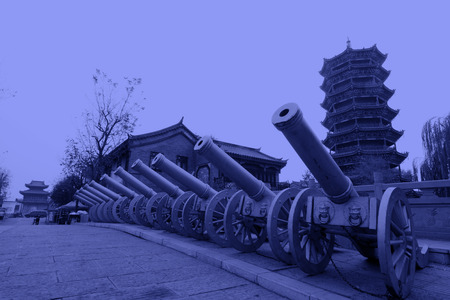 LUAN COUNTY - NOVEMBER 23: Copper artillery and antique buildings in Luanzhou city, on november 23, 2014, Luan County, Hebei Province, Chinaのeditorial素材