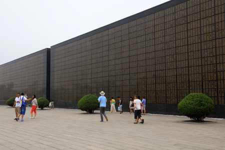 Tangshan City - July 8: Tourists in front of the memorial wall, Tangshan earthquake museum, on July 8, 2016, Tangshan city, Hebei province, Chinaのeditorial素材