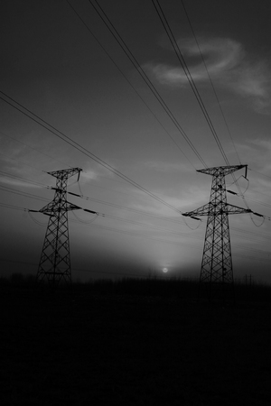 electric tower in the evening sky, power transmission facilitiesの写真素材