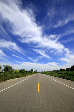 highway under the blue sky white cloudの写真素材