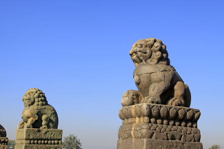 stone lion on bridge railing, Chinaの写真素材