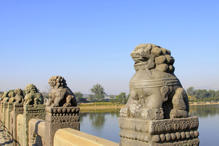 stone lion on bridge railing, Chinaの写真素材