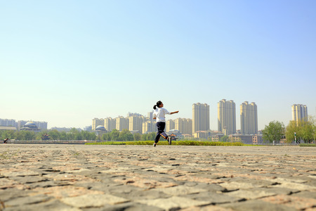 A Chinese girl flying a kite in the squareのeditorial素材