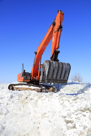 Luannan County - January 23, 2018: Excavator collate ice in the field, Luannan County, Hebei Province, Chinaのeditorial素材