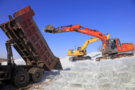 Luannan County - January 23, 2018: Excavator collate ice in the field, Luannan County, Hebei Province, Chinaのeditorial素材